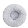 Donut Mand Dog Accessories, a light gray plush pet bed with a round shape, shaggy fabric, and raised cushioned rim